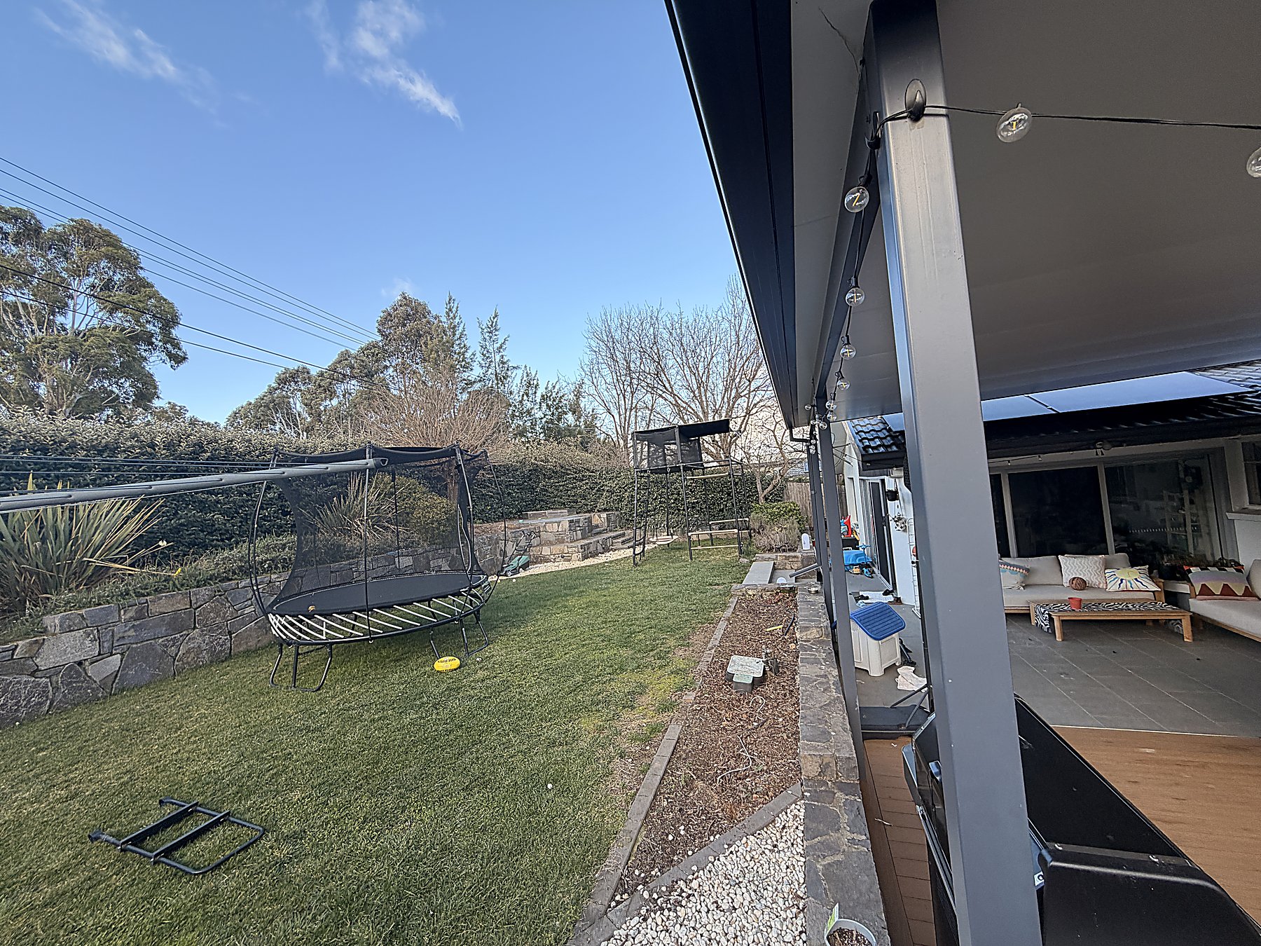 Backyard lawn and deck — Mowtion Gardens, Canberra
